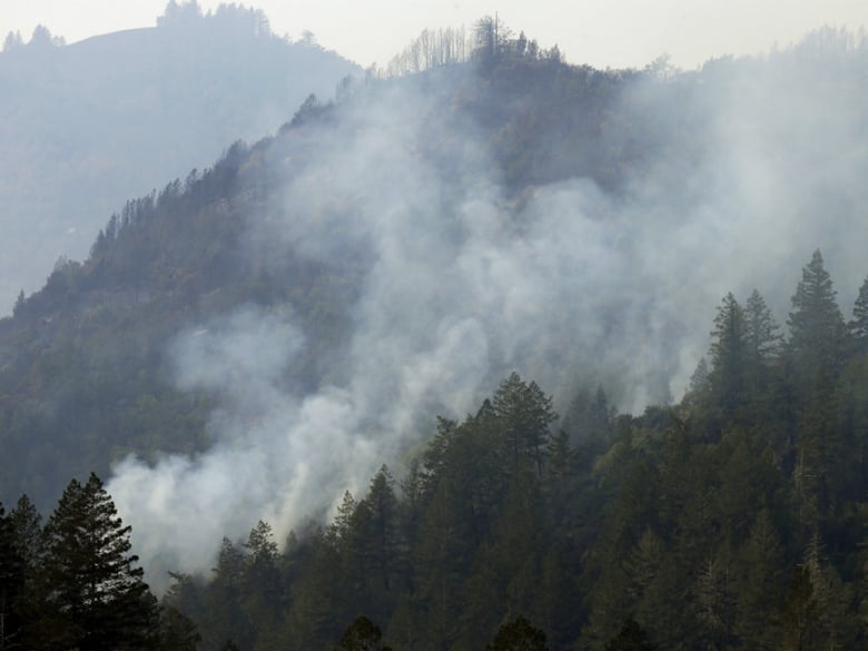 Smoke rises from a wildfire on Wednesday, Oct. 11, 2017 near Calistoga, Calif.